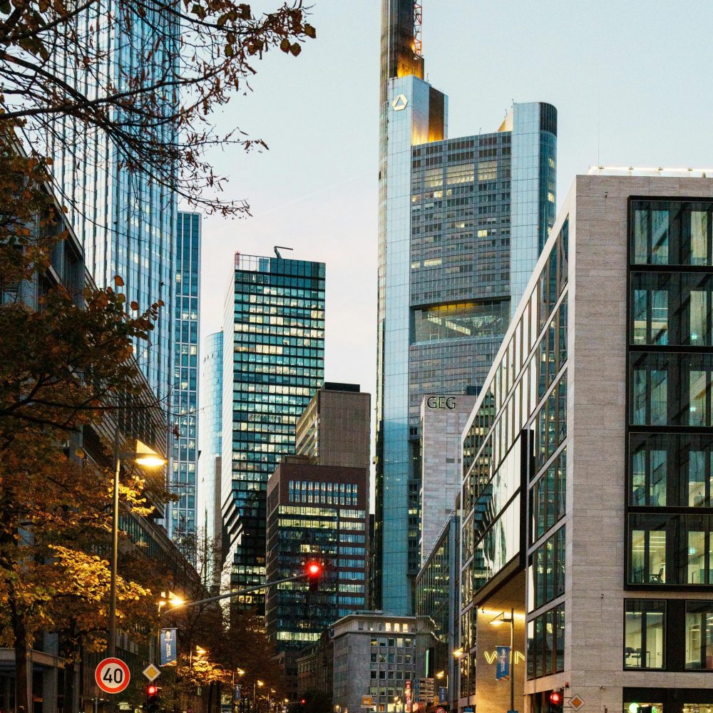 Stunning view of Frankfurt skyline featuring iconic skyscrapers and city lights during twilight.